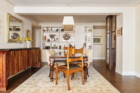 a dining room with furniture and wooden floor