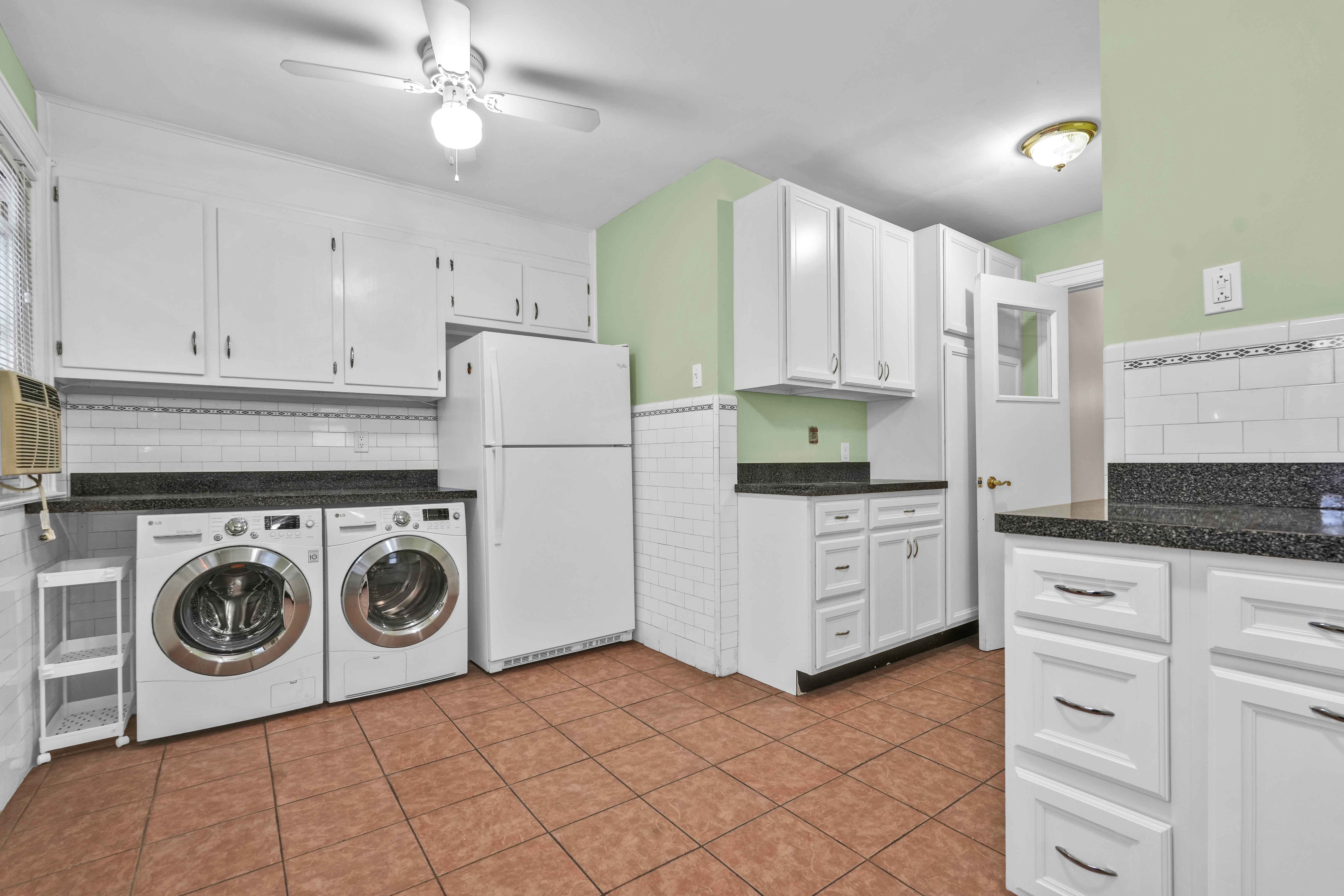 188-22 Lewiston Avenue, Unit 1 Queens, NY 11412 - Photo 9 of 17 a kitchen with cabinets and a stove top oven