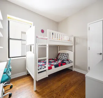 a bedroom with bed and window