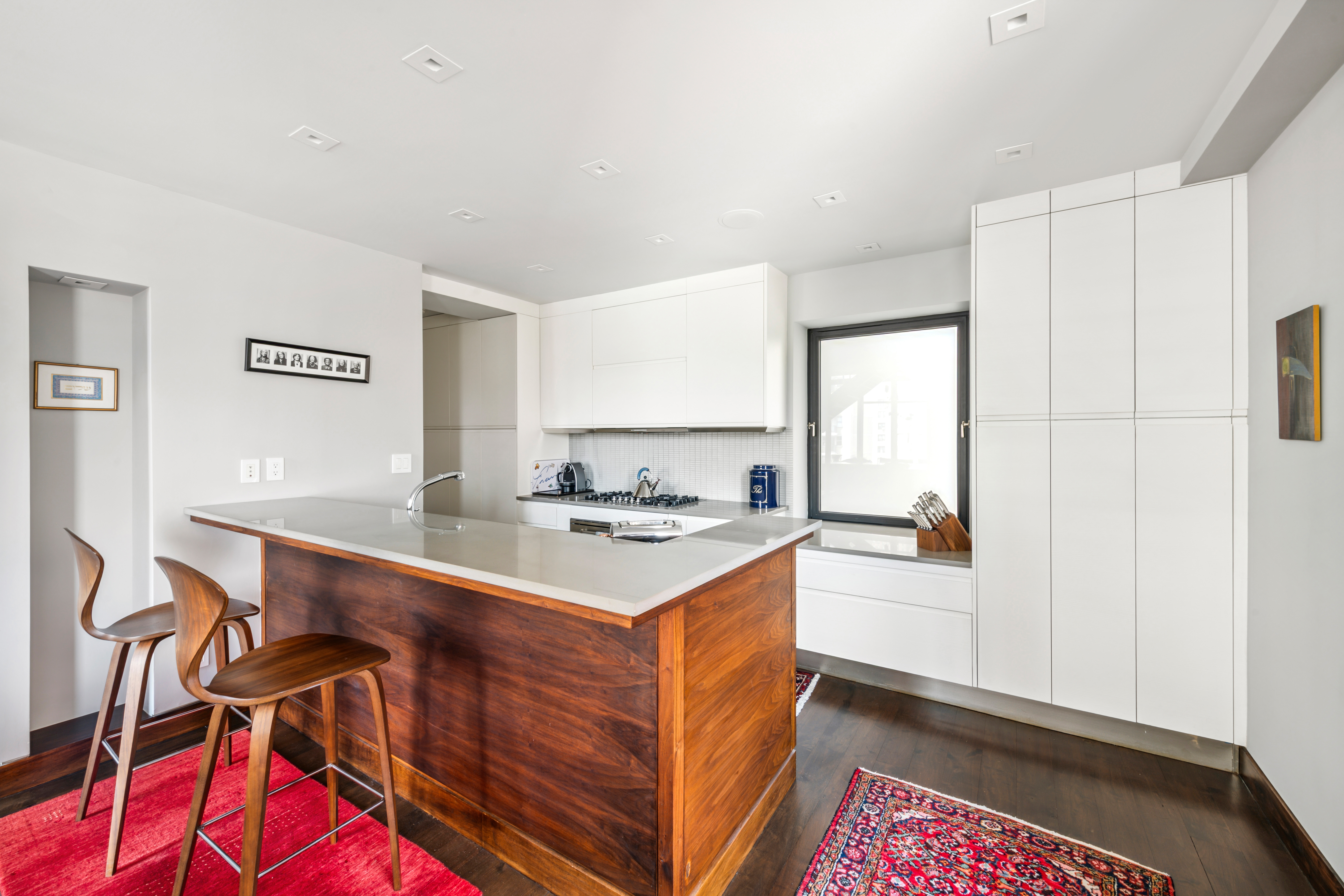 1 West 67th Street, Unit 707 Manhattan, NY 10023 - Photo 6 of 21 a kitchen with a stove and a refrigerator