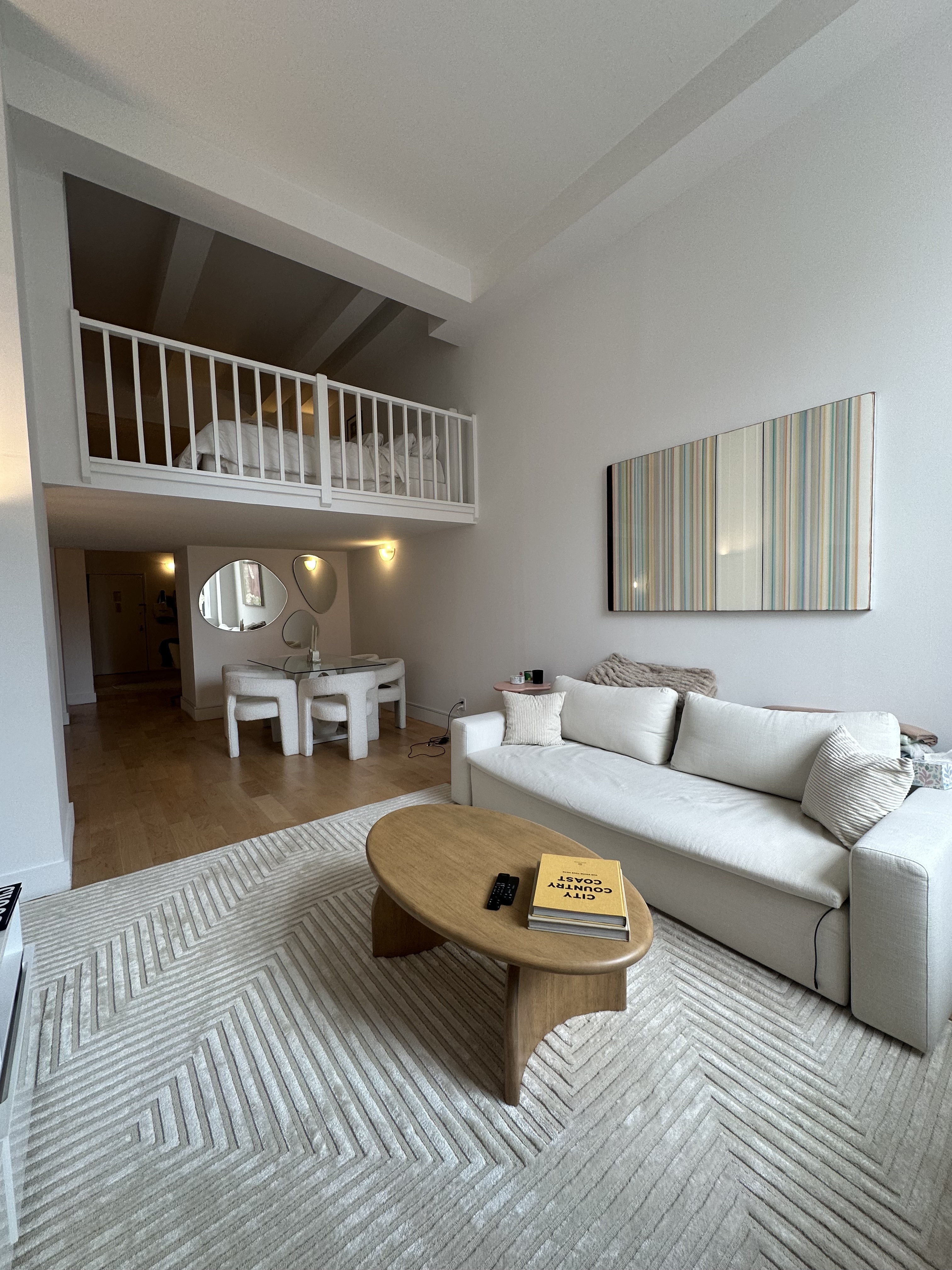 666 Greenwich Street, Unit 350 Manhattan, NY 10014 - Photo 1 of 13 a living room with furniture and a book shelf