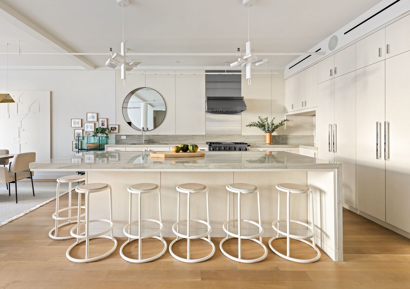 a kitchen with a sink and chairs