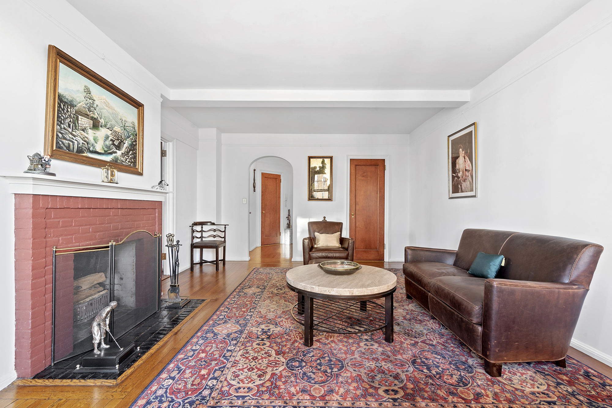 302 West 12th Street, Unit 12C Manhattan, NY 10014 - Photo 3 of 13 a living room with furniture and a fireplace