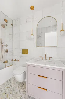 a bathroom with a sink a toilet and mirror