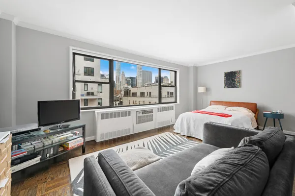 a bedroom with two beds and a flat screen tv