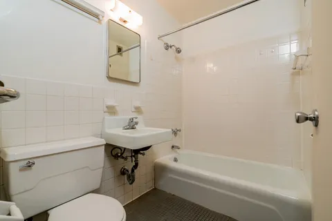 a bathroom with a sink a toilet and bathtub