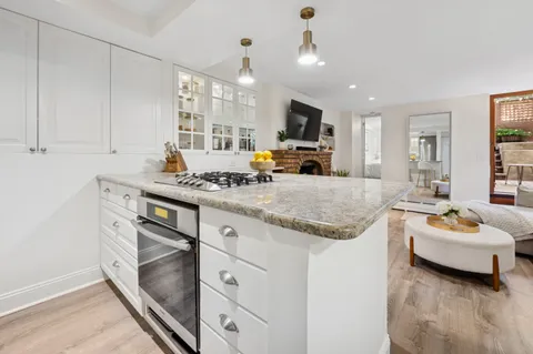 a kitchen with stainless steel appliances granite countertop a stove and a sink
