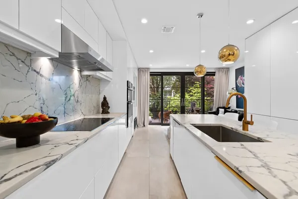 a large white kitchen with a large window