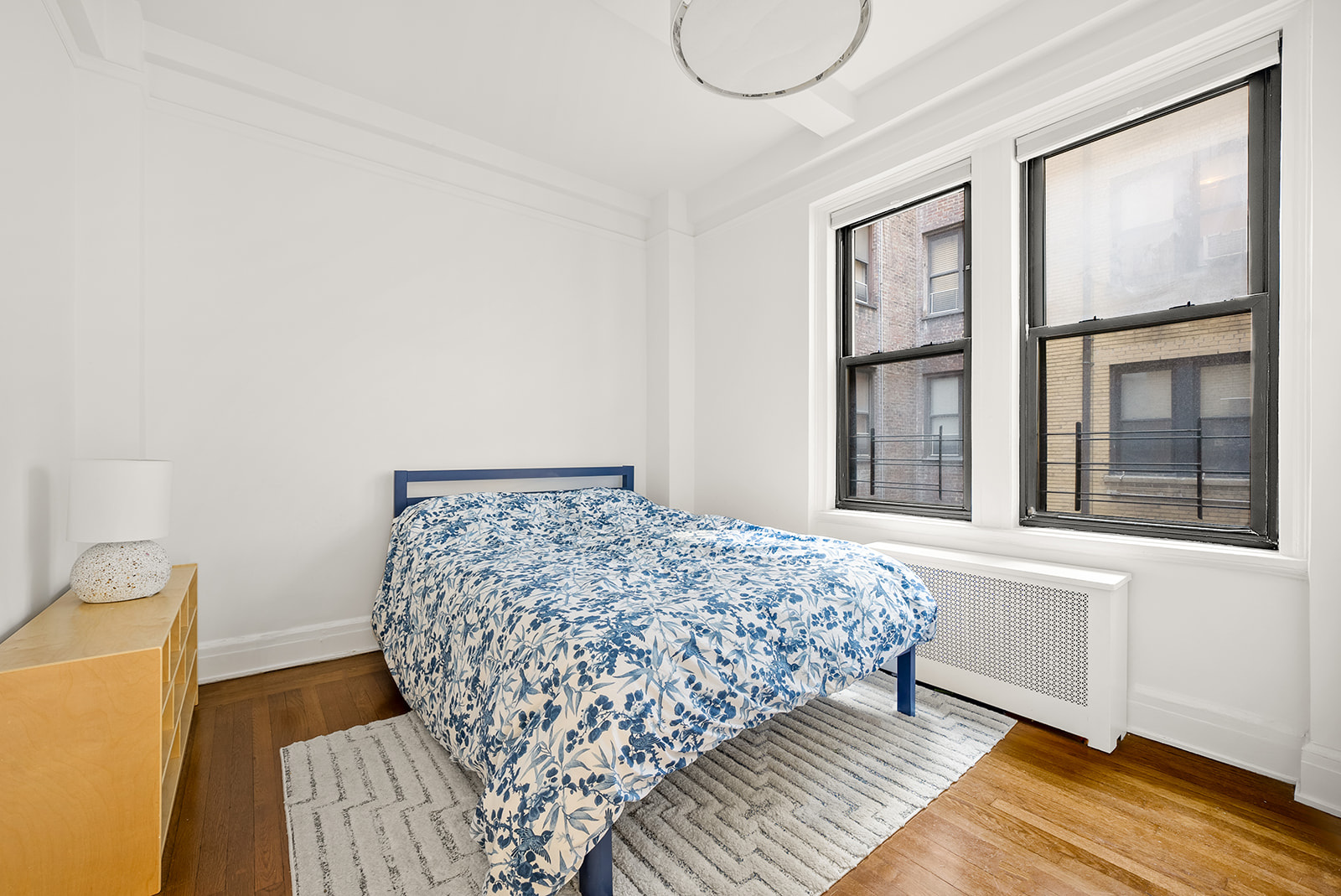 152 West 58th Street, Unit 6CD Manhattan, NY 10019 - Photo 4 of 9 a bedroom with a bed and a window