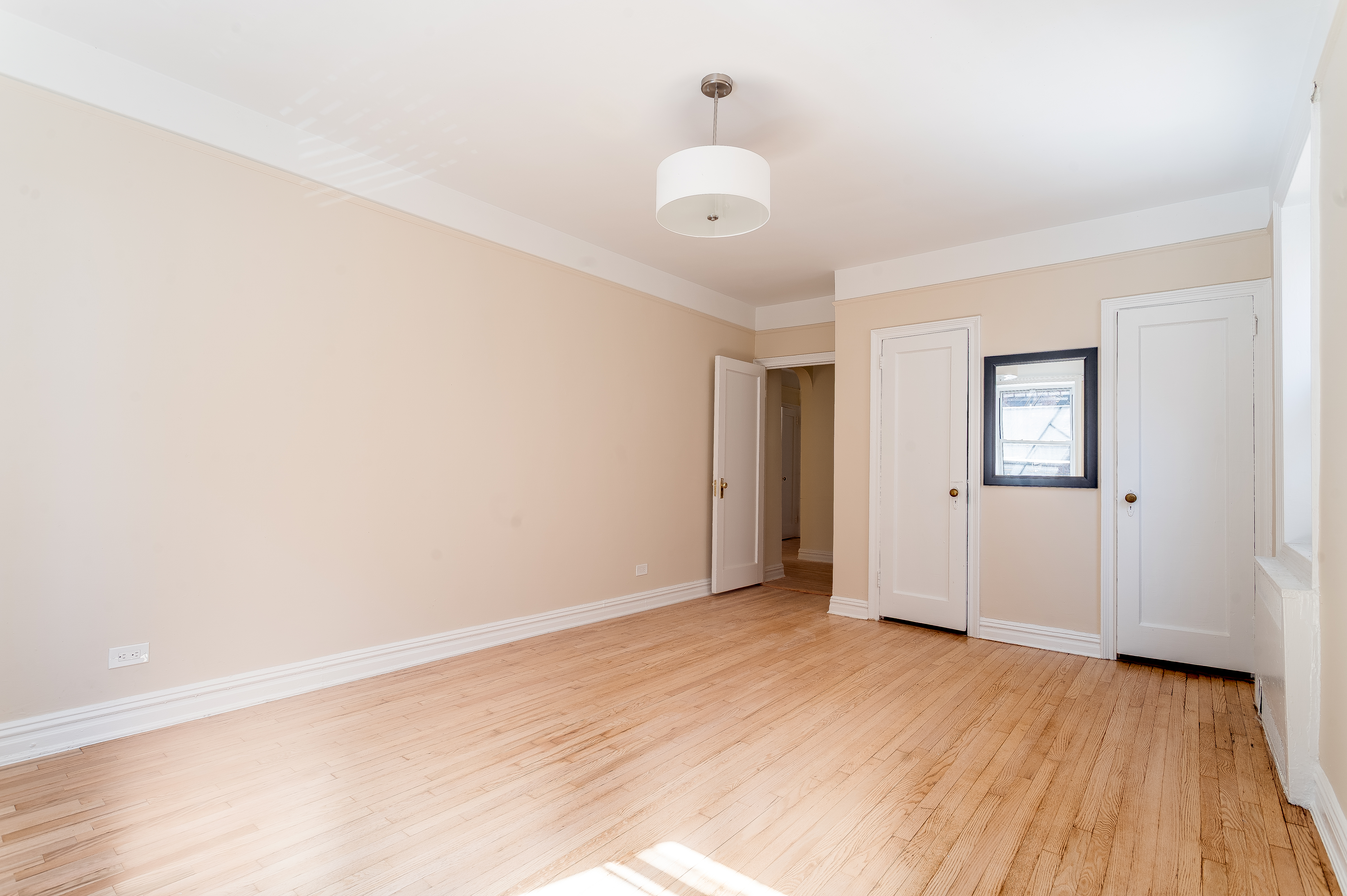 40 Tehama Street, Unit 2E Brooklyn, NY 11218 - Photo 6 of 12 an empty room with wooden floor and windows