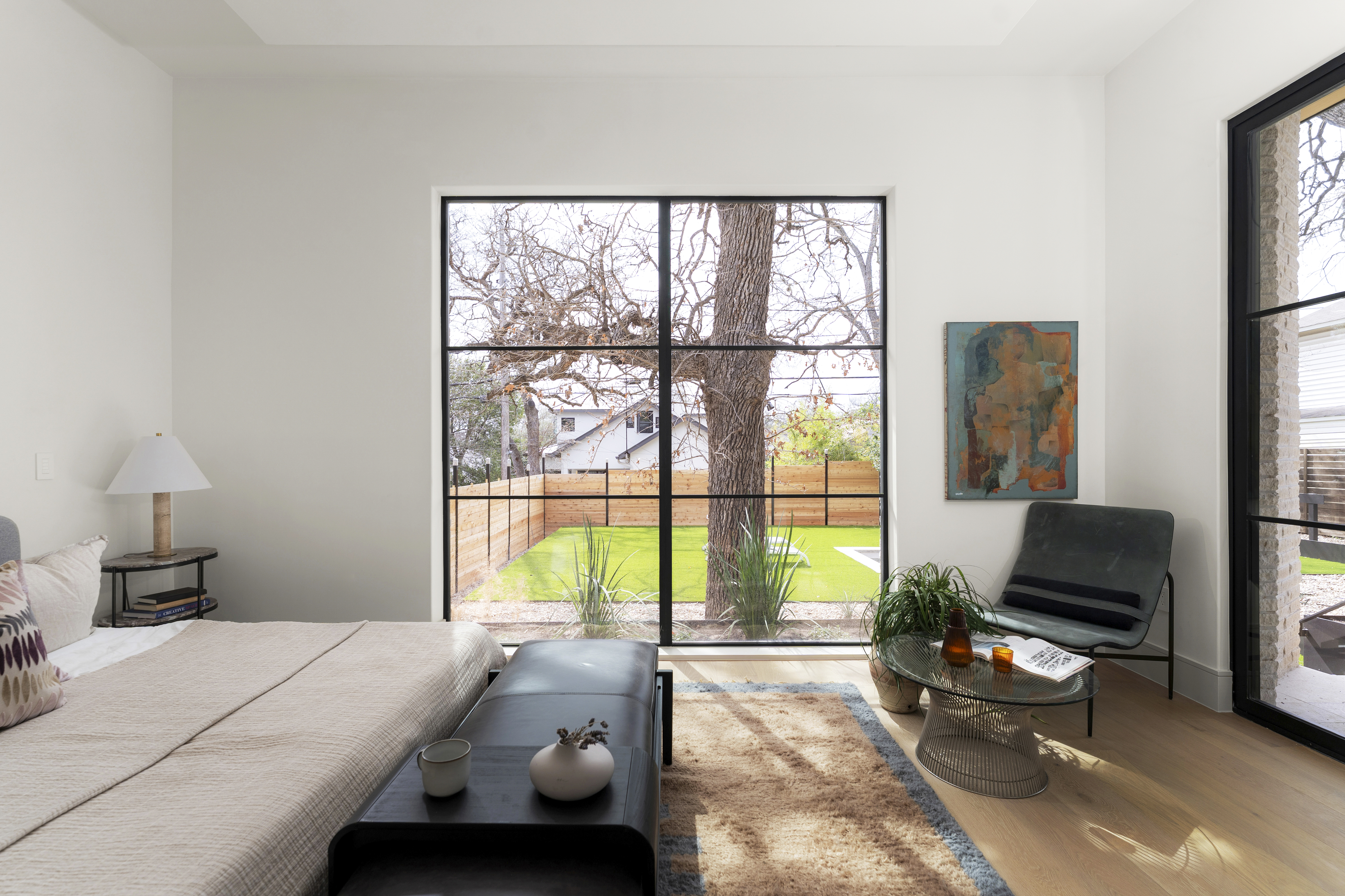 3411 Bridle Path Austin, TX 78703 - Photo 20 of 76 a bedroom with a bed a large window and a flat tv screen next to a large window