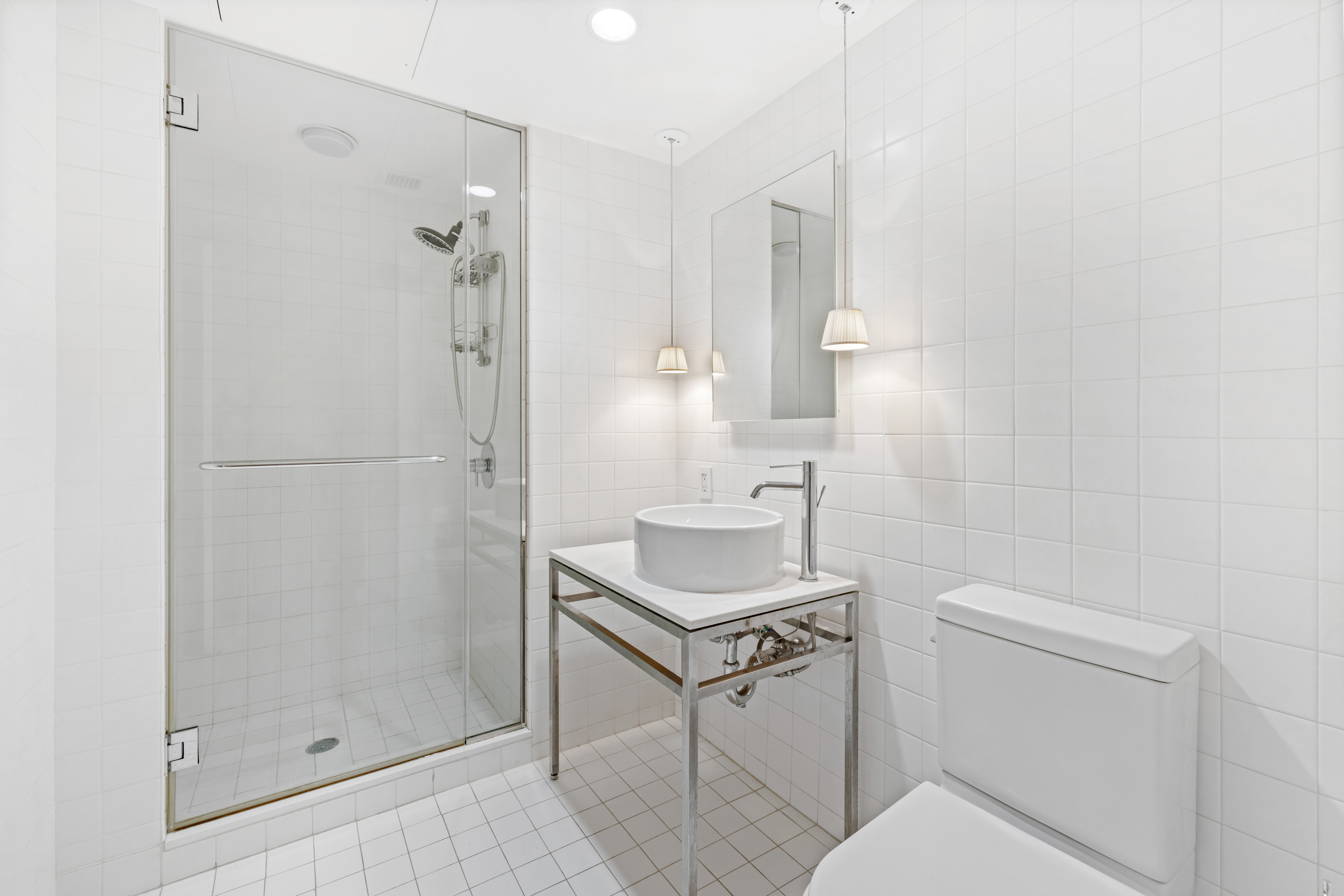 15 Broad Street, Unit 3930 Manhattan, NY 10005 - Photo 9 of 20 a bathroom with a sink toilet and shower