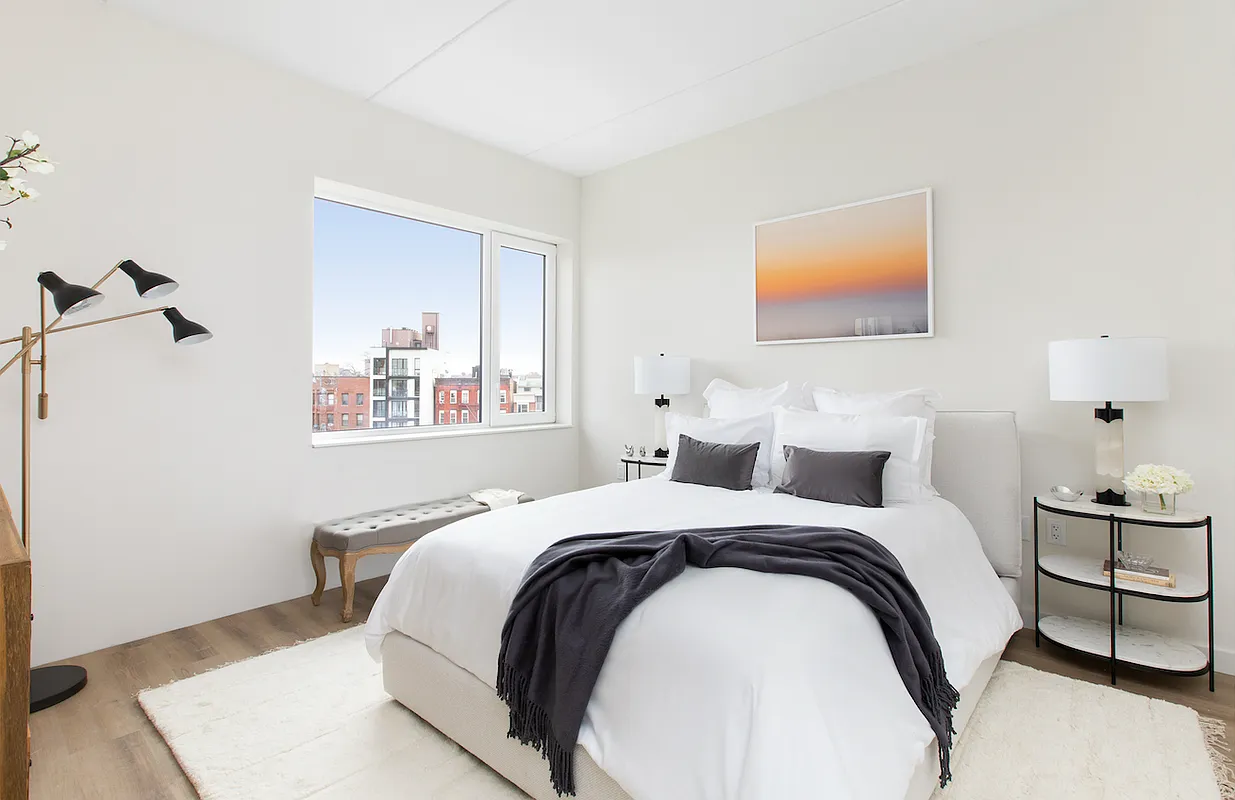 8 Palmetto Street, Unit 713 Brooklyn, NY 11221 - Photo 3 of 23 a bedroom with a bed and a lamp with the wooden floor