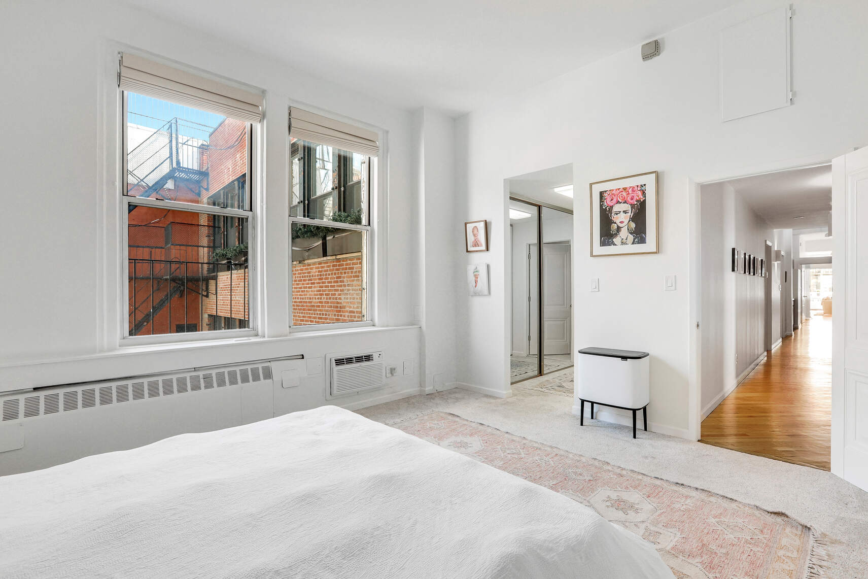 35 East 12th Street, Unit 8C Manhattan, NY 10003 - Photo 10 of 22 a bedroom with a bed and a large window