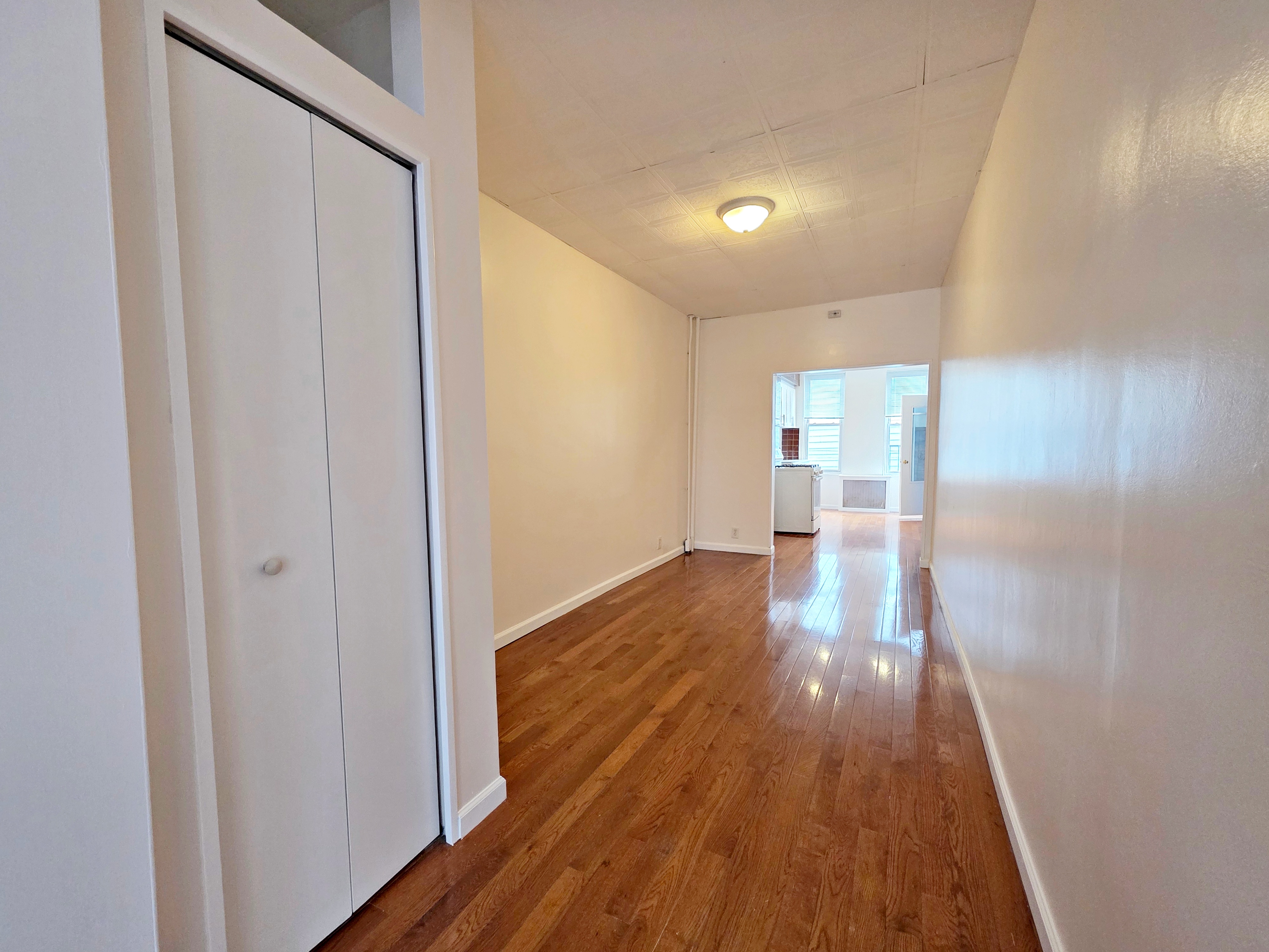 396 Manhattan Avenue, Unit 2L Brooklyn, NY 11211 - Photo 3 of 7 a view of a hallway with wooden floor