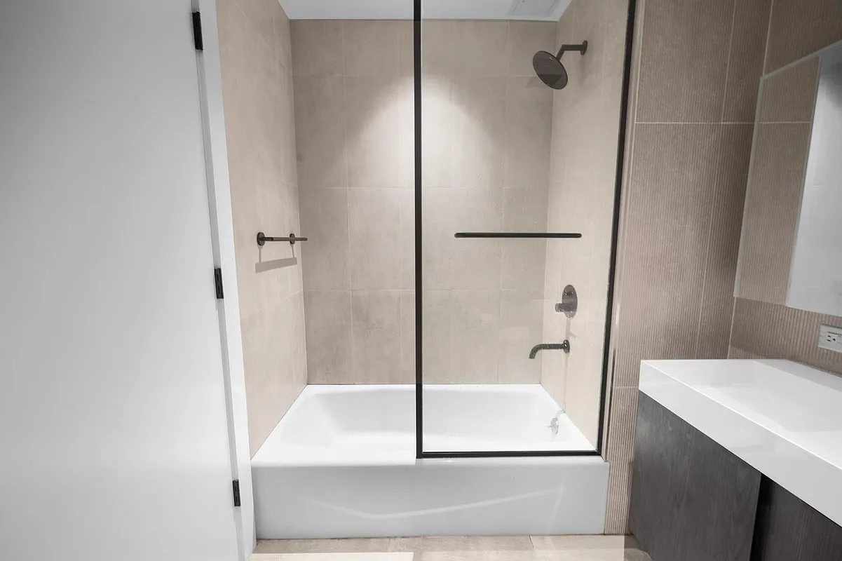 169 Huron Street, Unit 4A Brooklyn, NY 11222 - Photo 9 of 15 a bathroom with a bathtub and a shower