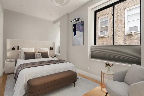 a bedroom with a bed and a couch