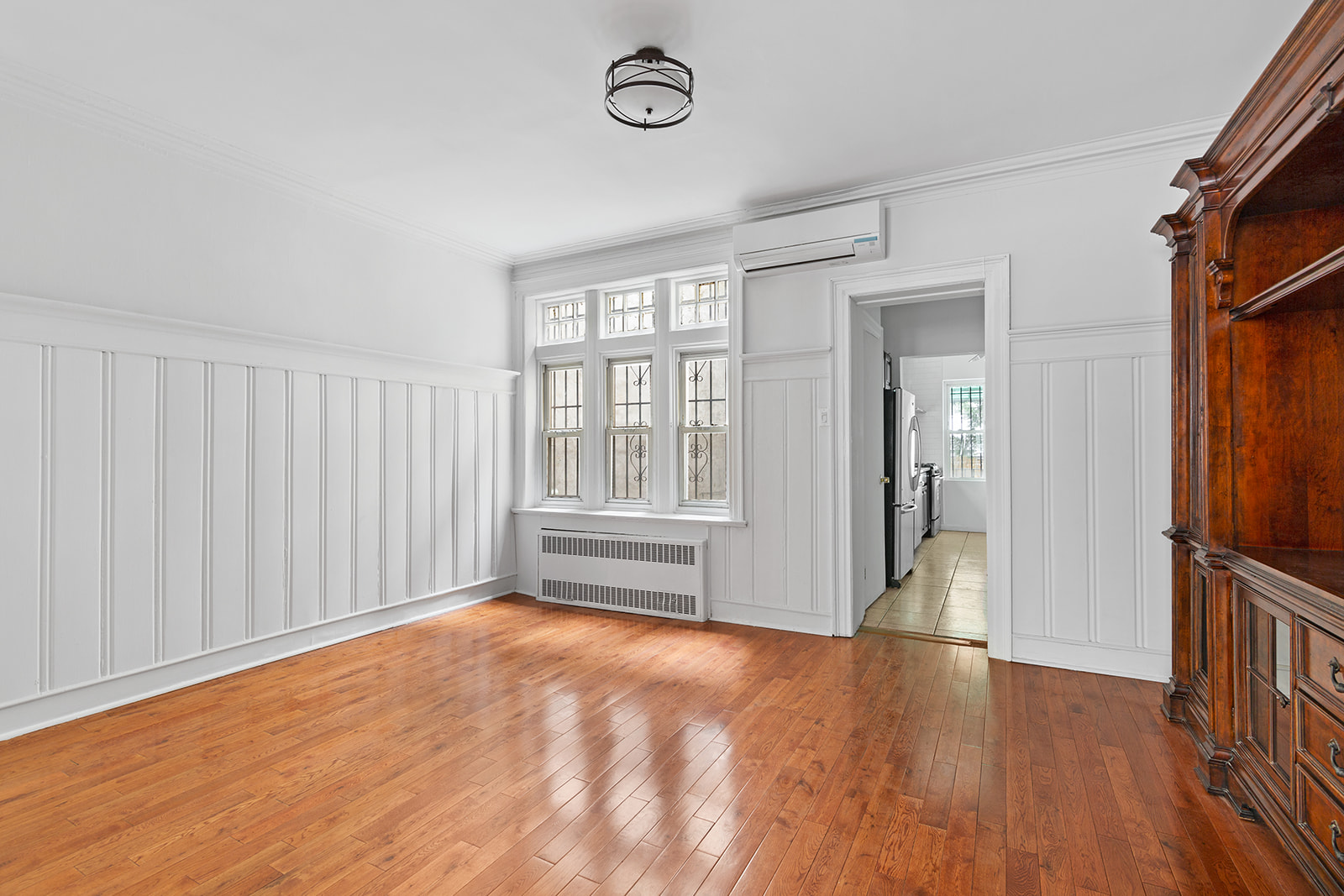 165 Fenimore Street Brooklyn, NY 11225 - Photo 3 of 13 a view of empty room with wooden floor and fan