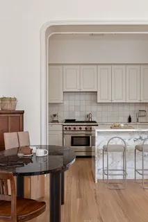a kitchen with a stove a sink and a refrigerator