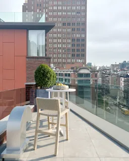 a balcony with table and chairs