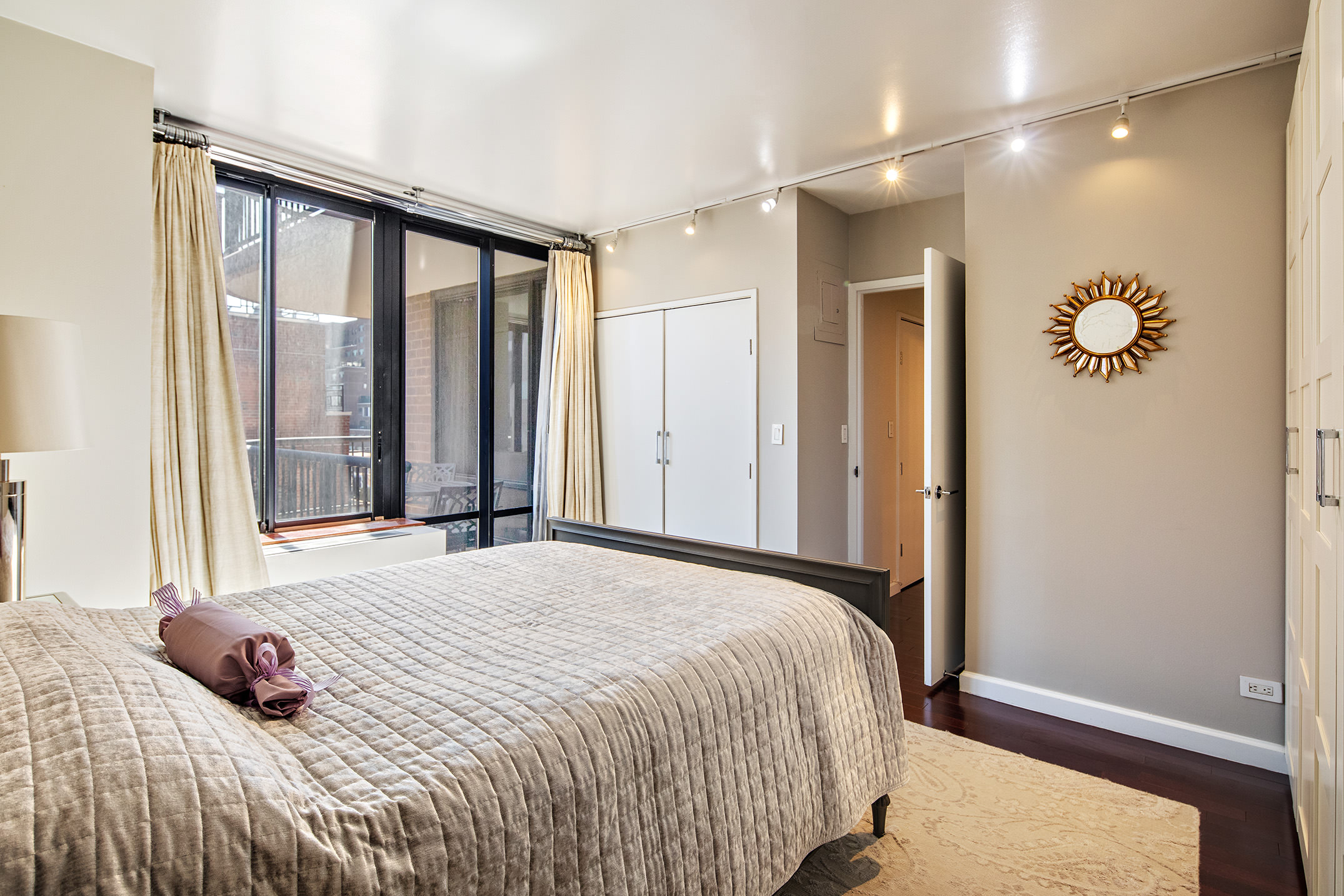 304 East 65th Street, Unit 10D Manhattan, NY 10065 - Photo 5 of 14 a bedroom with a large bed and a window