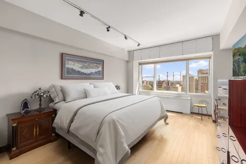 a bed room with a bed and a large window