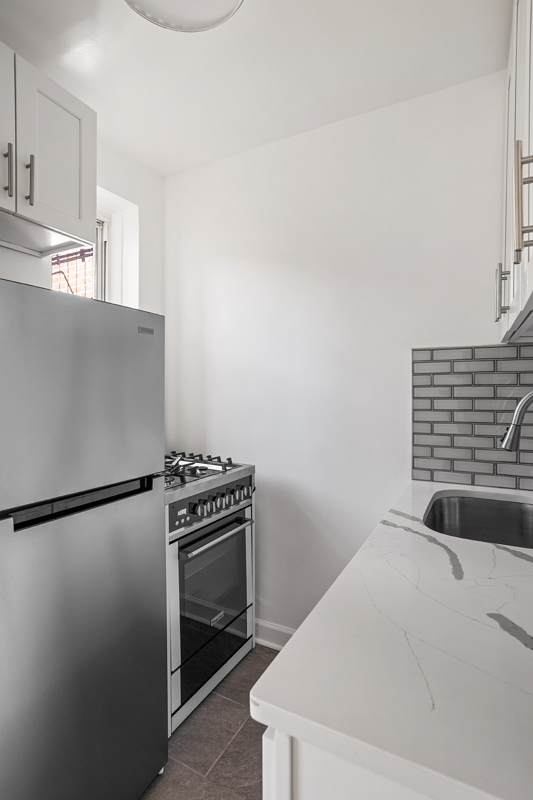 33-35 81st Street, Unit 5A Queens, NY 11372 - Photo 5 of 12 a kitchen with a refrigerator and a stove