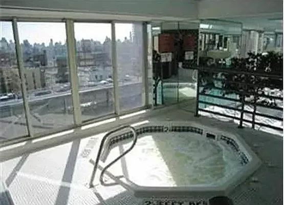 a view of a livingroom with furniture and floor to ceiling window