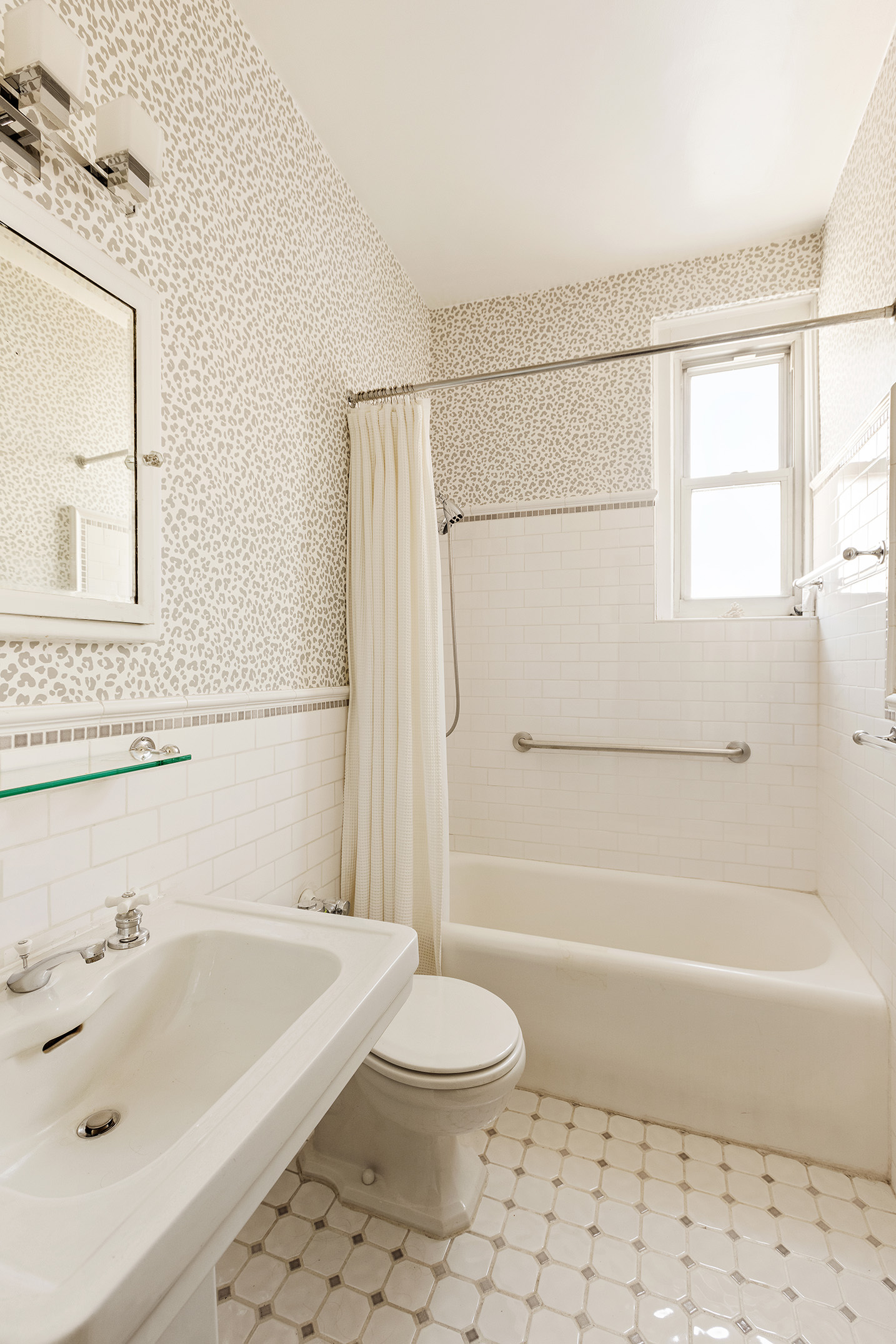 139 East 94th Street, Unit 7D Manhattan, NY 10128 - Photo 8 of 11 a bathroom with a sink a toilet and a shower