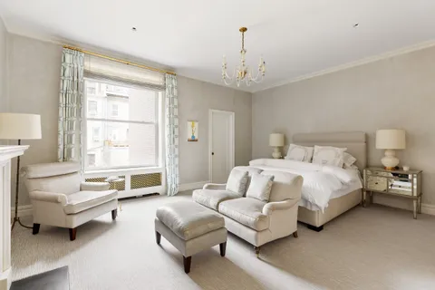 a bedroom with a bed couch and a window