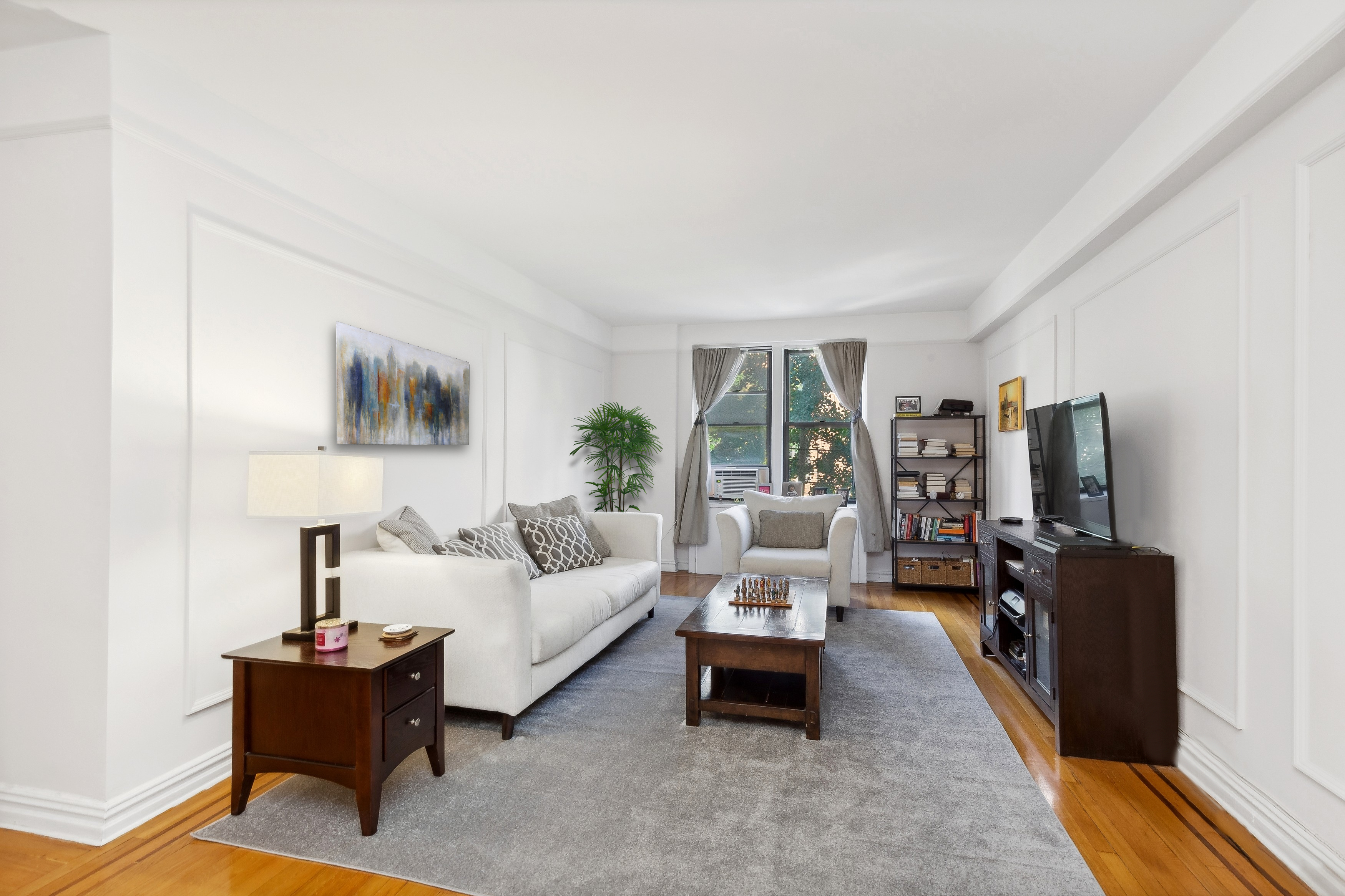 736 West 186th Street, Unit 5B Manhattan, NY 10033 - Photo 1 of 16 a living room with furniture and a flat screen tv