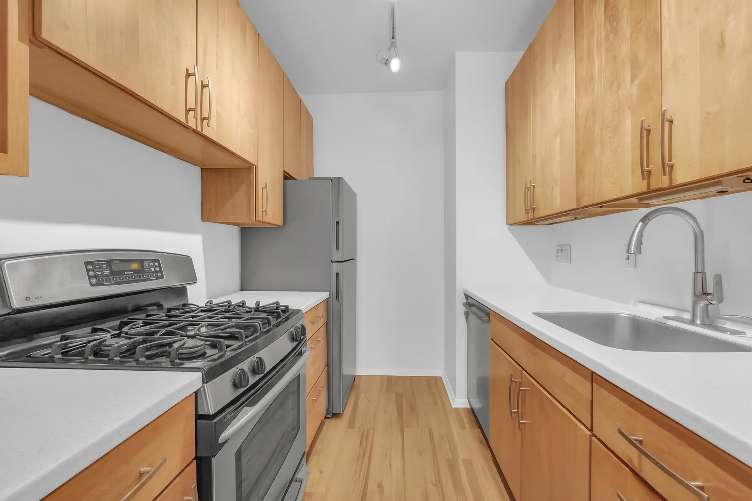 a kitchen with a sink a stove and cabinets