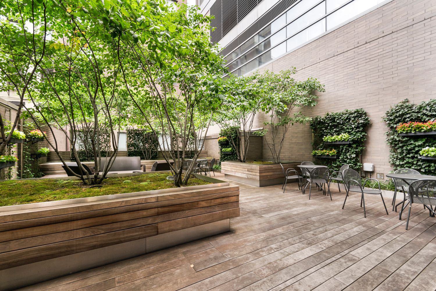 255 East 74th Street, Unit 20C Manhattan, NY 10021 - Photo 13 of 16 a view of backyard with table and chairs and potted plants