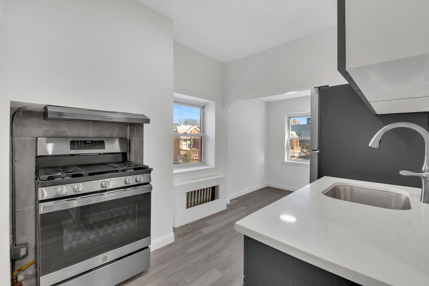 7001 Shore Road, Unit 2 Brooklyn, NY 11209 - Photo 9 of 17 a kitchen with granite countertop a stove and a sink