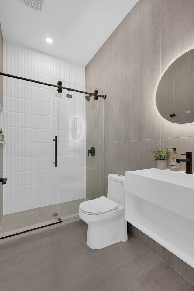 97 Seigel Street, Unit 2R Brooklyn, NY 11206 - Photo 4 of 7 a bathroom with a toilet a sink and shower