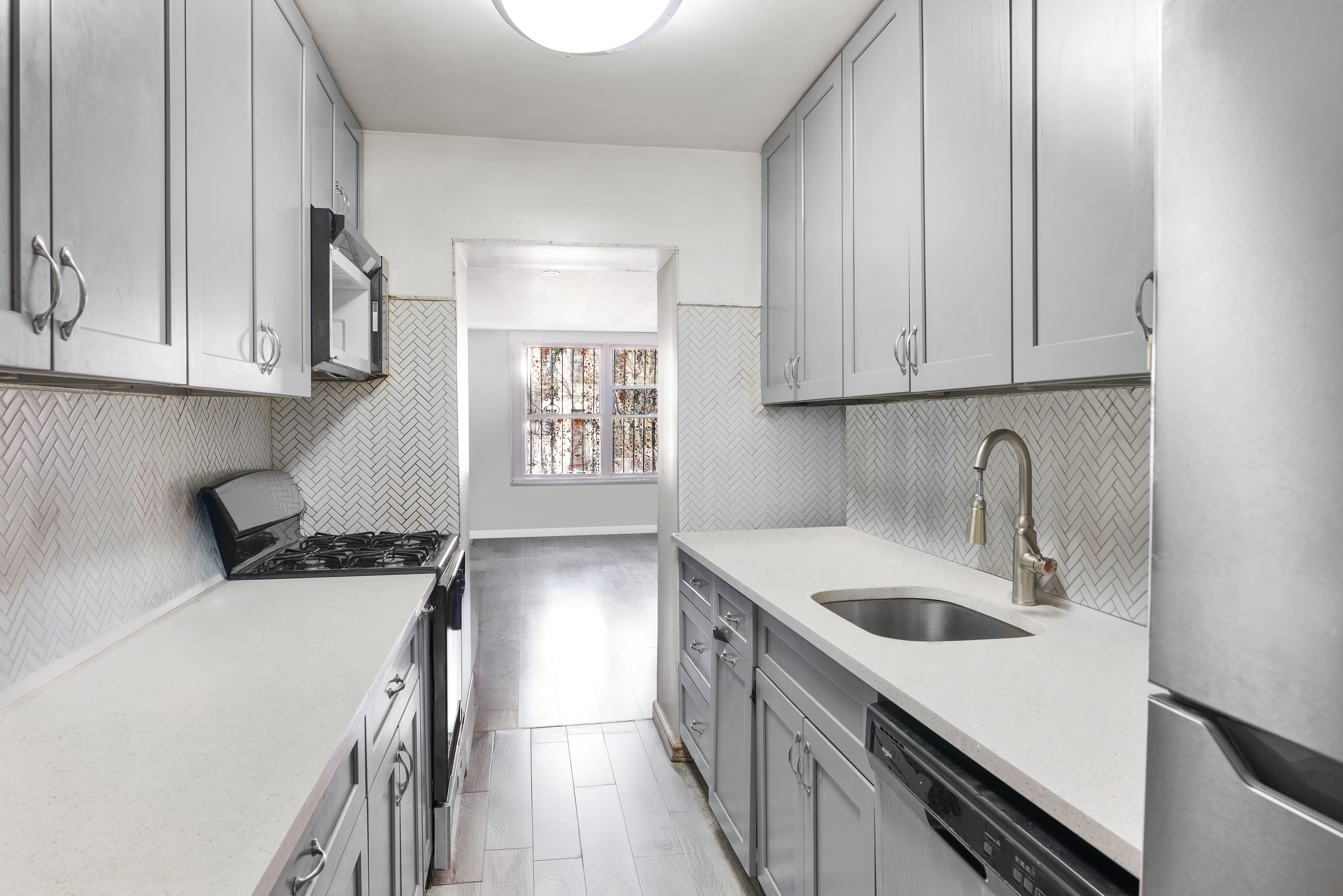 364 Chauncey Street Brooklyn, NY 11233 - Photo 3 of 17 a kitchen with a sink a stove and cabinets