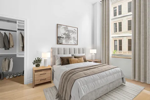 a bedroom with bed and wooden floor