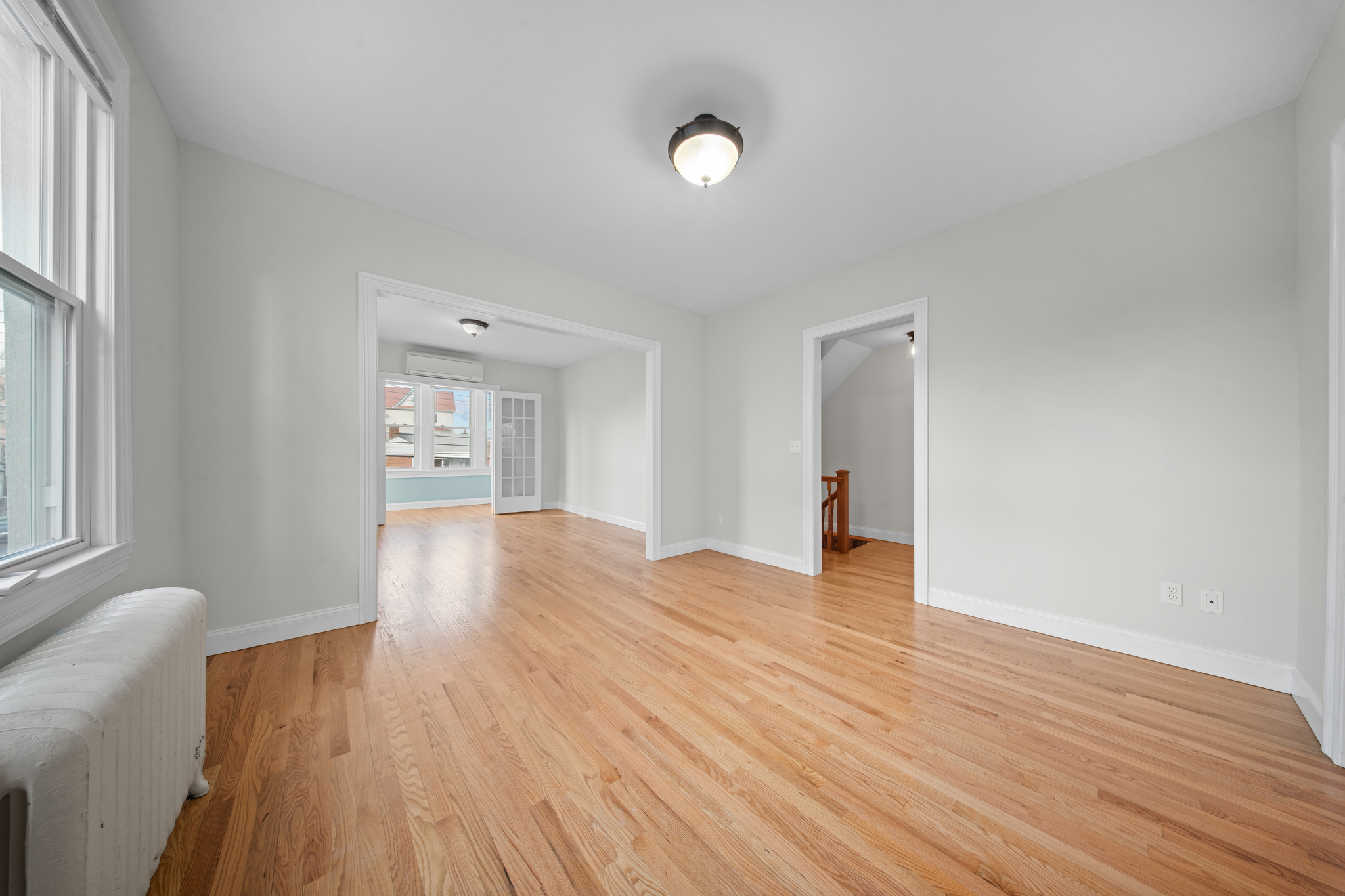 52-19 69th Street Queens, NY 11378 - Photo 16 of 35 a view of empty room with wooden floor and fan