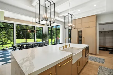 a kitchen with granite countertop cabinets a dining table and chairs