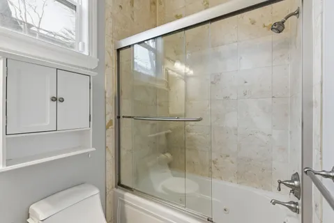 a bathroom with a shower and a toilet