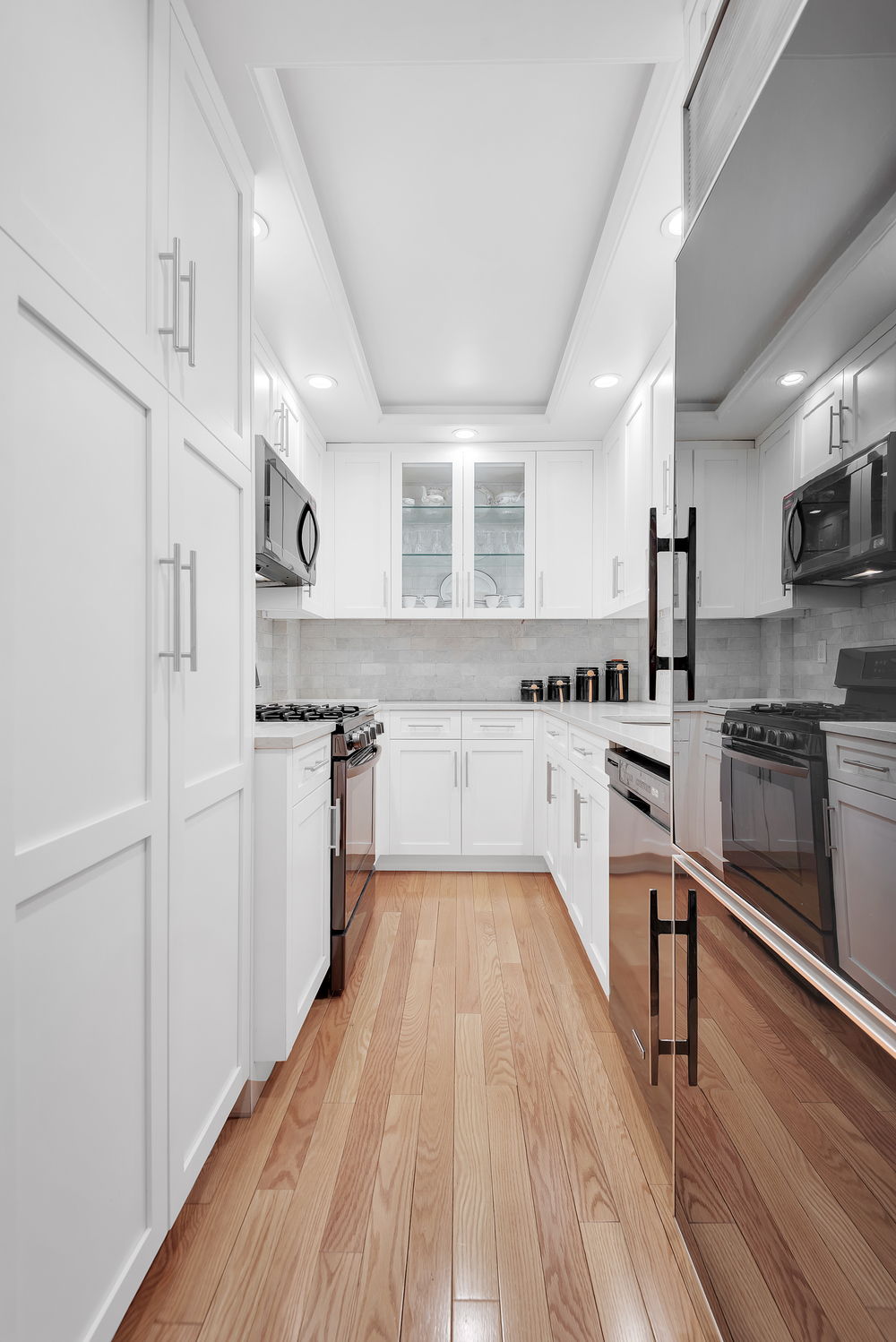 315 East 69th Street, Unit 4E Manhattan, NY 10021 - Photo 3 of 8 a kitchen with kitchen island a counter top space a stove a sink and a refrigerator