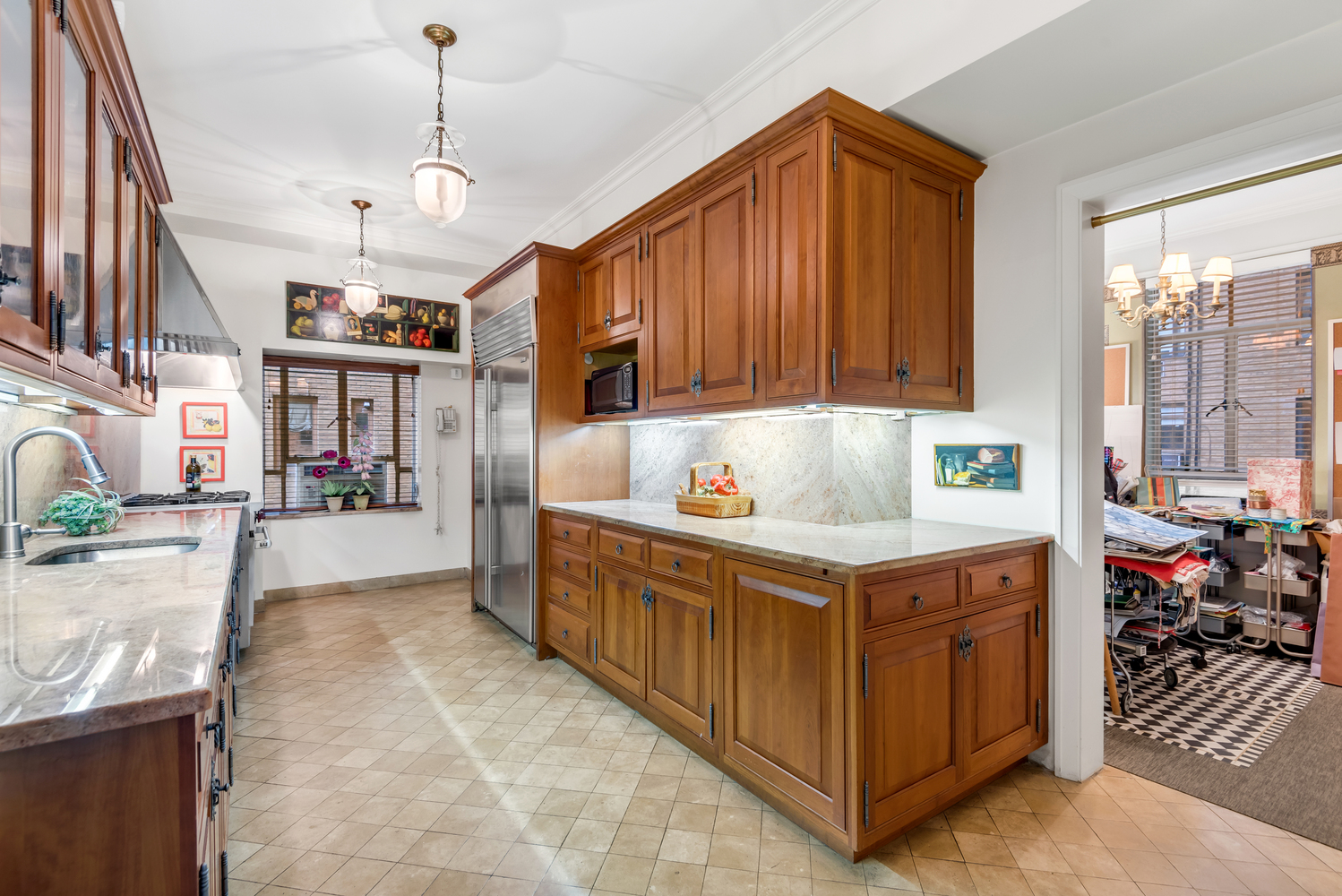 115 Central Park West, Unit 3B Manhattan, NY 10023 - Photo 6 of 20 a kitchen that has a lot of cabinets in it