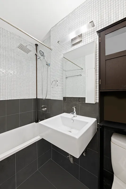 35 East 10th Street, Unit 2G Manhattan, NY 10003 - Photo 9 of 11 a bathroom with a sink and a mirror