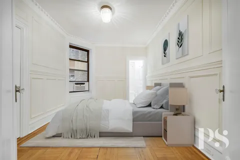 a living room with furniture and a baby crib