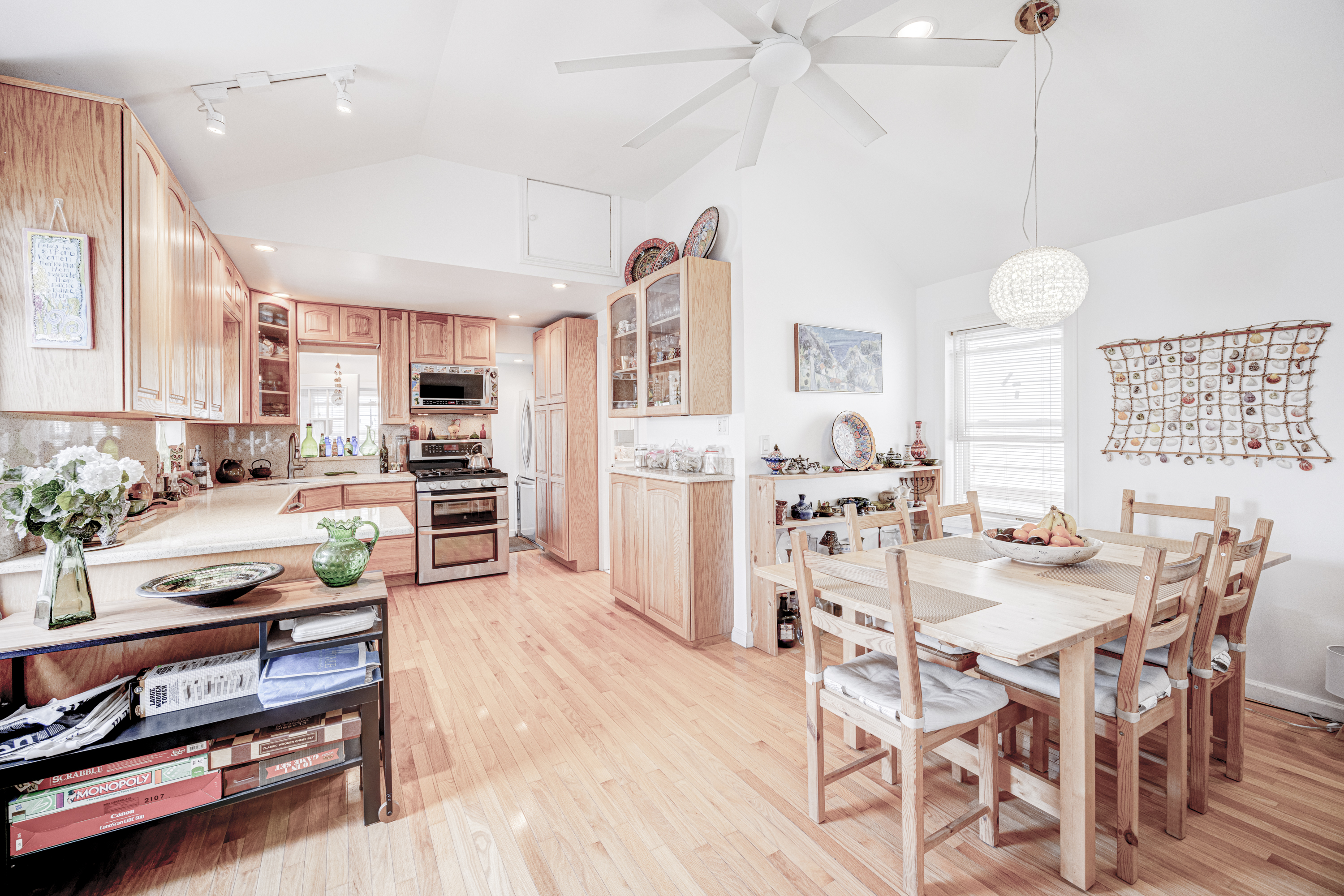 355 D Dormans Court Queens, NY 11693 - Photo 5 of 21 a kitchen with stainless steel appliances kitchen island granite countertop a table chairs in it and wooden floors