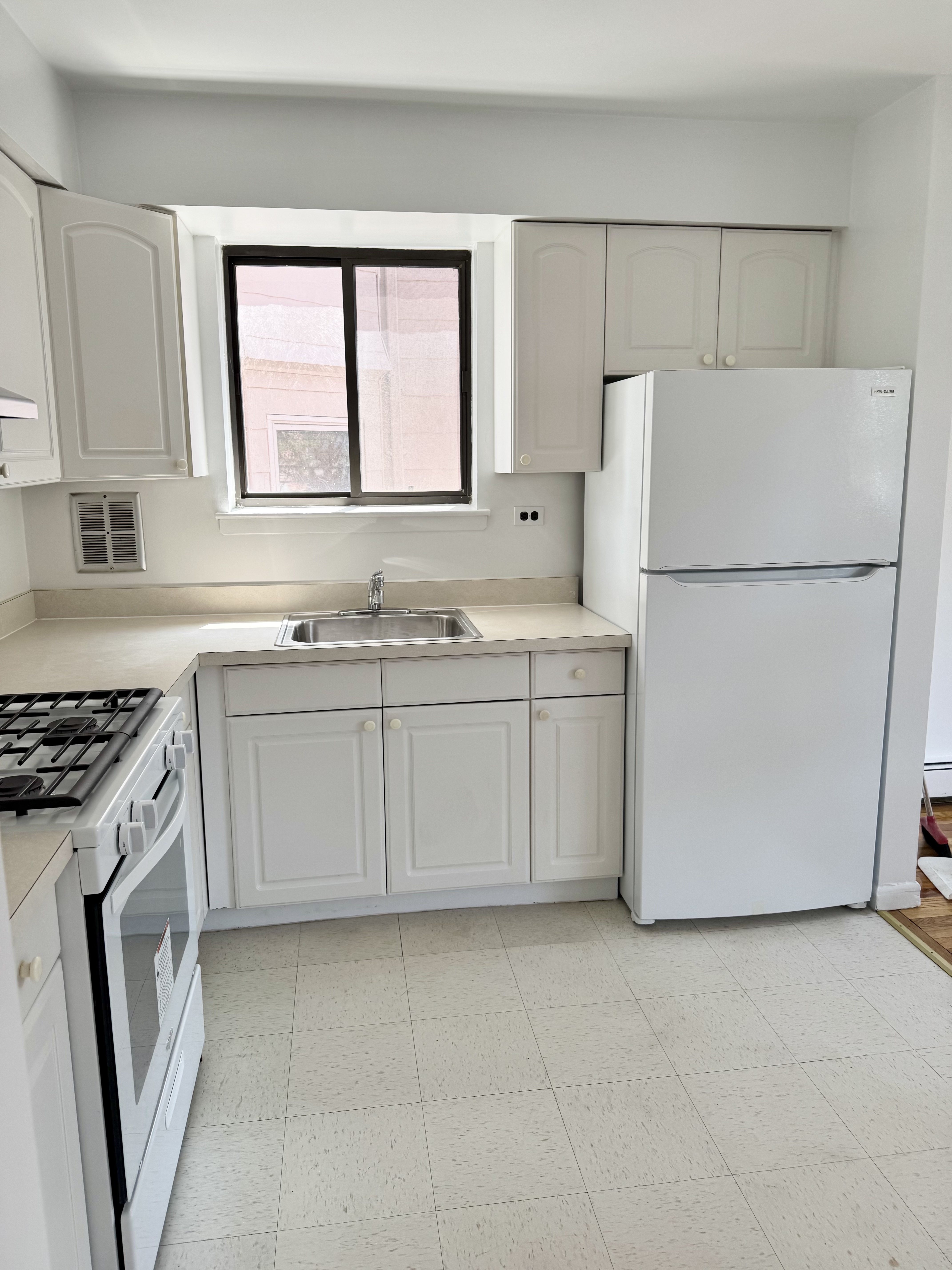 a kitchen with a stove a sink and a refrigerator