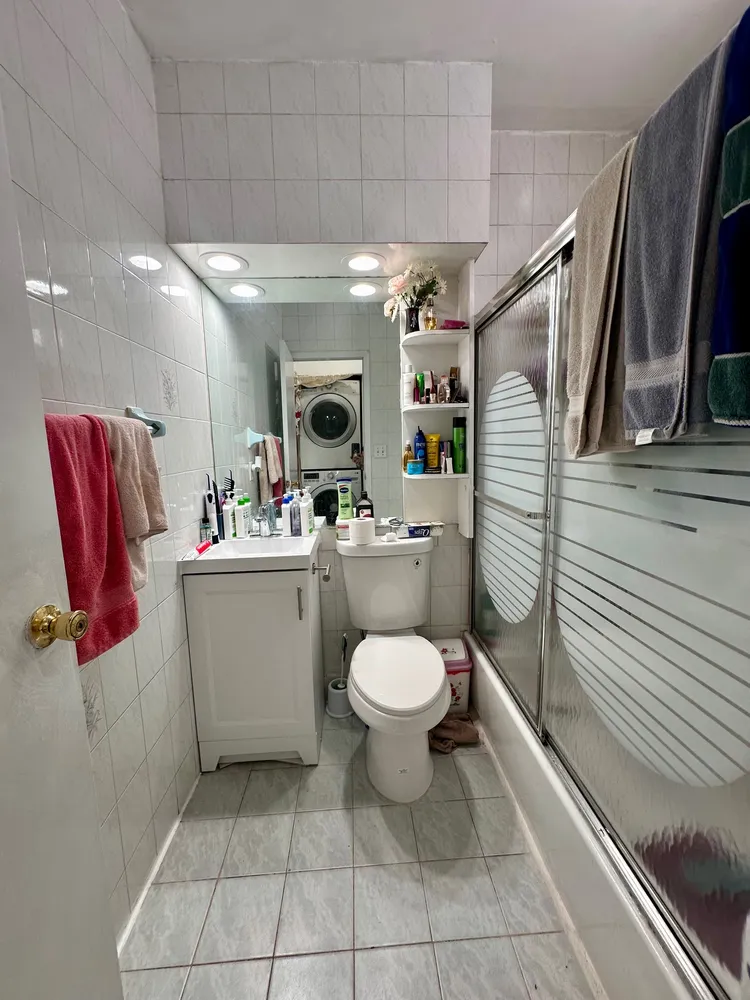 a bathroom with a toilet sink and mirror