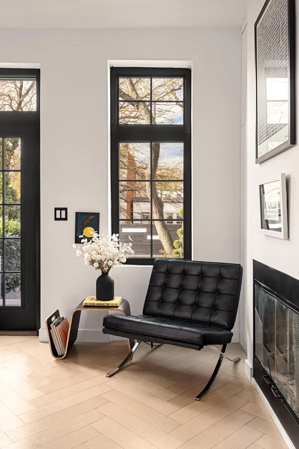 a living room with furniture a rug and a floor to ceiling window