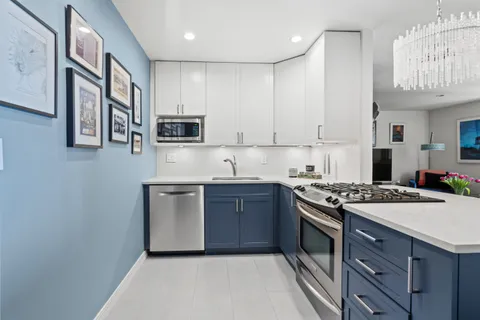 a kitchen with stainless steel appliances granite countertop a stove sink microwave and cabinets