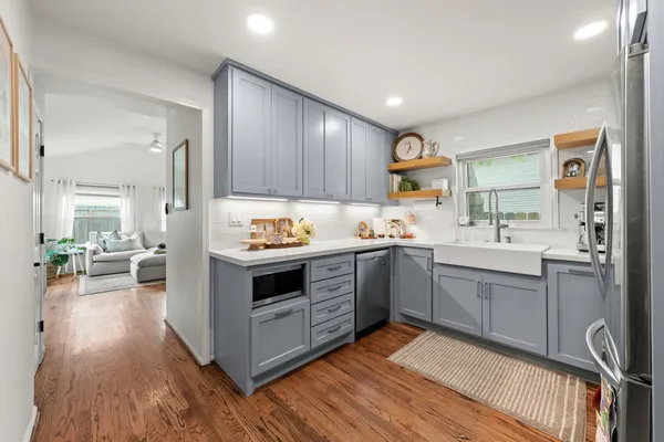 a kitchen with sink cabinets and wooden floor
